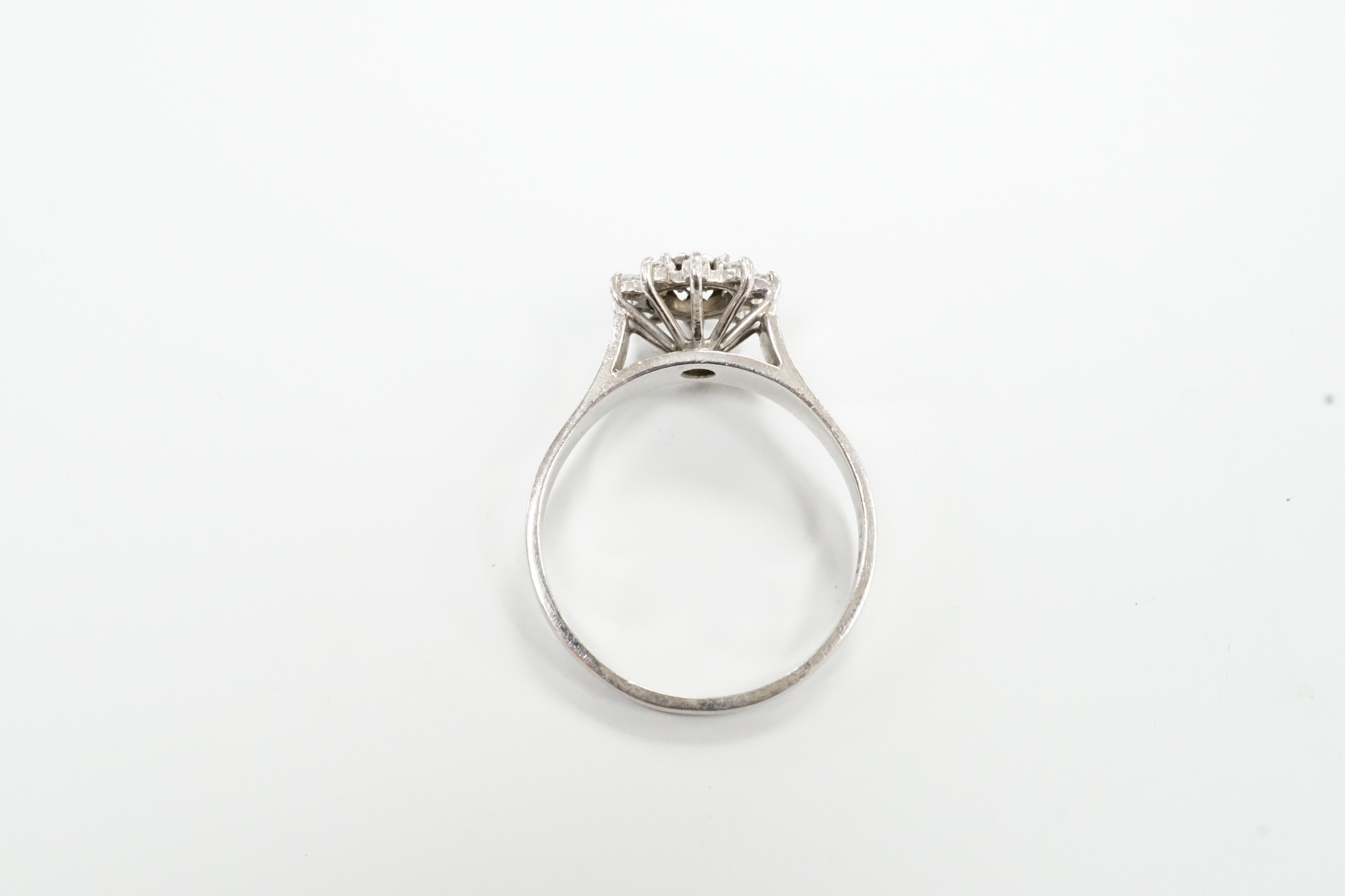 A modern 18ct white metal and diamond cluster set flower head ring, size U, gross weight 5 grams.